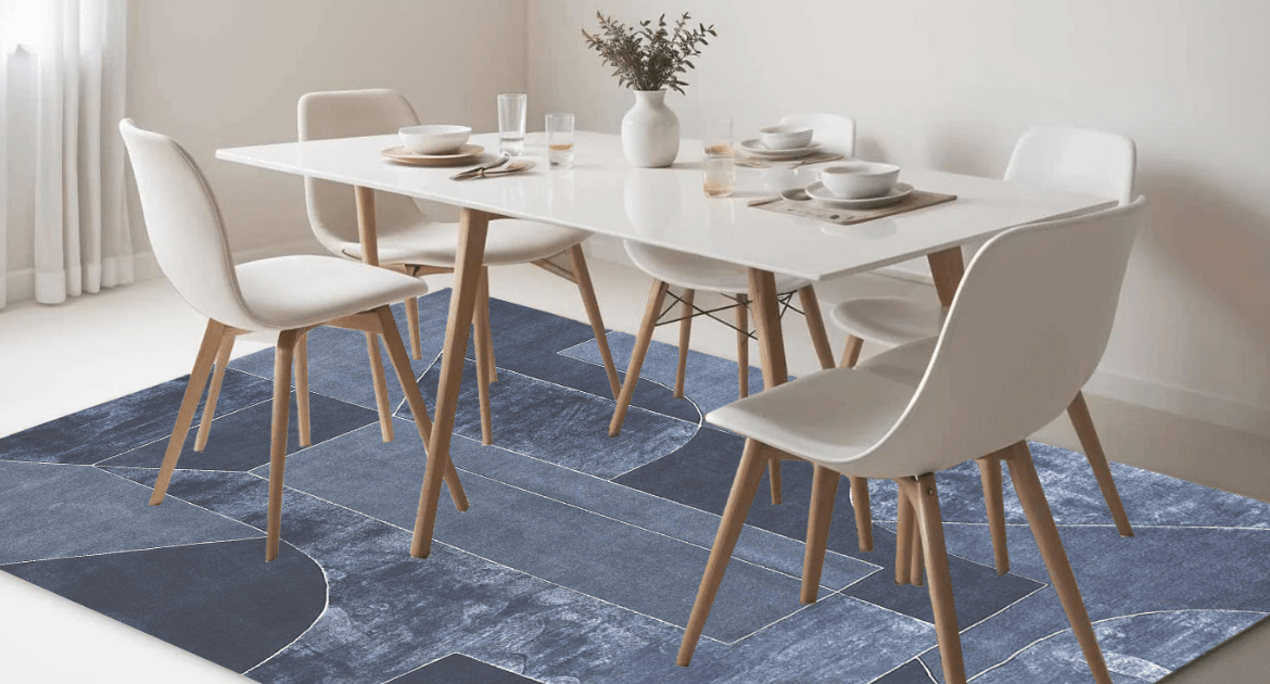 Blue handmade modern carpet placed under the dining table on white marble flooring